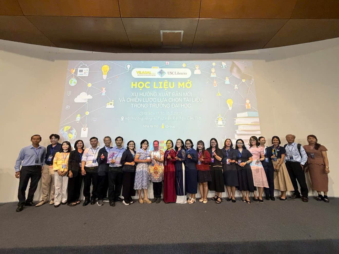 A group of people standing in front of a screen

Description automatically generated